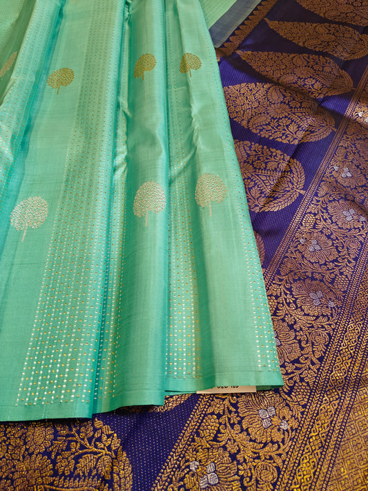 Borderless Light Teal Body with Gold and Silver Zari Vertical Lines and Big Gold and Silver Tree Buttas. Patli Pallu Jamun Purple
